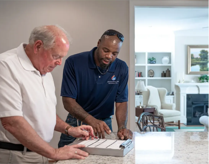 Markus Roberson explaining HVAC equipment to a homeowner